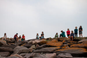 People on top of rocks taking part in Maharees Sound wlk