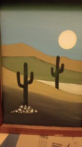 Painting of desert scene with tall cactus - road runner type